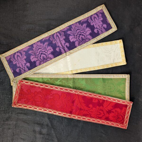Four Apparrelled Amices In Purple, White, Green and Red
