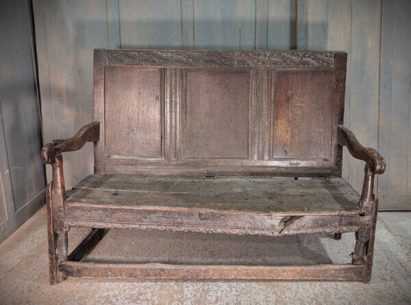 Early 17th Century Oak Panel Back Settle with Carving