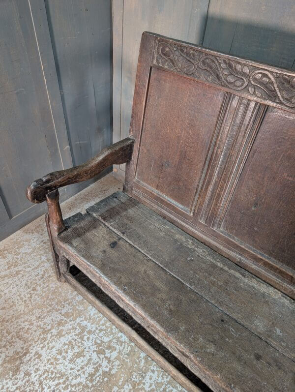 Early 17th Century Oak Panel Back Settle with Carving