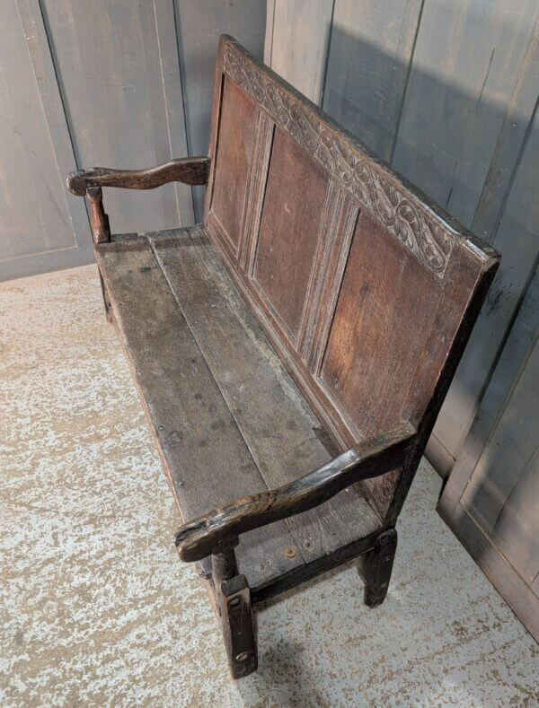 Early 17th Century Oak Panel Back Settle with Carving
