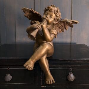 Large Vintage Composition Seated Figure of a Pipe Playing Putto Angel